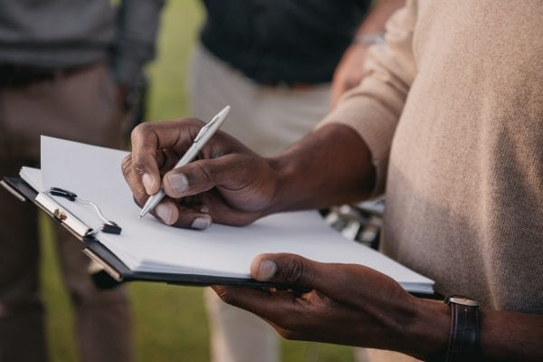 man holding clipboard completing PCA