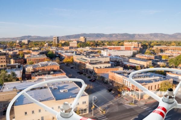 drones view flying over town with mountains