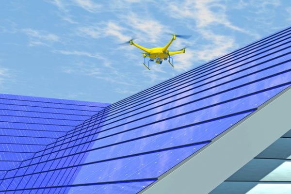 drones doing roof assessments on a blue futuristic roof