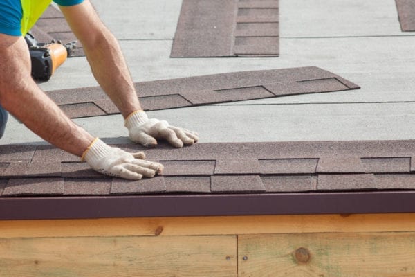 man on roof applying the roof type for your residence